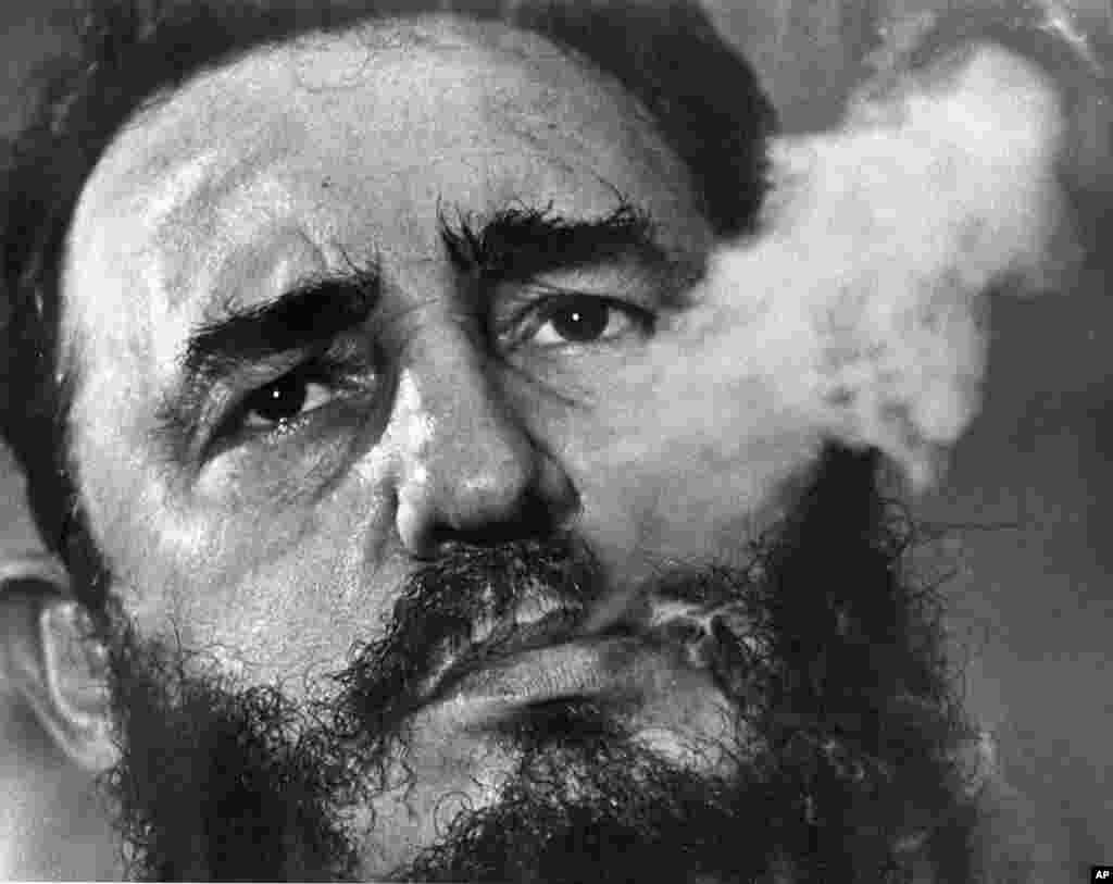 FILE - Cuban Prime Minister Fidel Castro exhales cigar smoke during an interview at his presidential palace in Havana, Cuba, March 1985. Castro, a Havana attorney who fought for the poor, overthrew dictator Fulgencio Batista's government on Jan. 1, 1959.