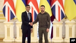 In this photo provided by Ukraine's Presidential Press Office, Ukrainian President Volodymyr Zelenskyy, right, shakes hands with British Prime Minister Rishi Sunak during their meeting in Kyiv, Ukraine, Nov. 19, 2022.