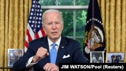 US President Joe Biden addresses the nation on averting default and the Bipartisan Budget Agreement, in the Oval Office of the White House in Washington, DC, June 2, 2023. JIM WATSON/Pool via REUTERS