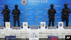 Police officers stand behind seized crystal methamphetamine during a news conference in Bangkok, Thailand, May 29, 2023.