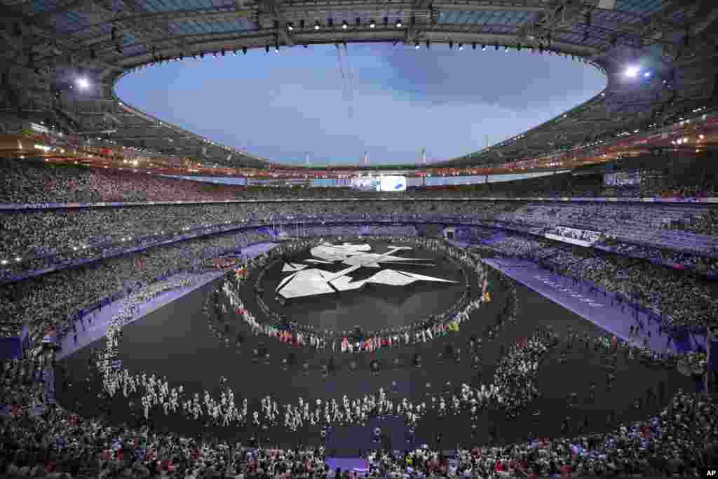 Flag bearers march during the 2024 Summer Olympics closing ceremony at the Stade de France, Aug. 11, 2024, in Saint-Denis, France. 