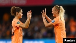 Netherlands' Dominique Janssen celebrates with Stefanie van der Gragt after the match against Portugal, July 23, 2023.