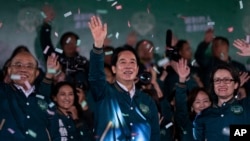 Taiwanese Vice President Lai Ching-te, also known as William Lai, left, celebrates his victory with running mate Bi-khim Hsiao, right, in Taipei, Taiwan, Jan. 13, 2024.