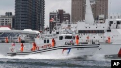 Crew members of the Taiwan Coast Guard salute after an offshore anti-terrorism drill outside the Kaohsiung harbor in Kaohsiung, southwestern Taiwan, June 10, 2023.