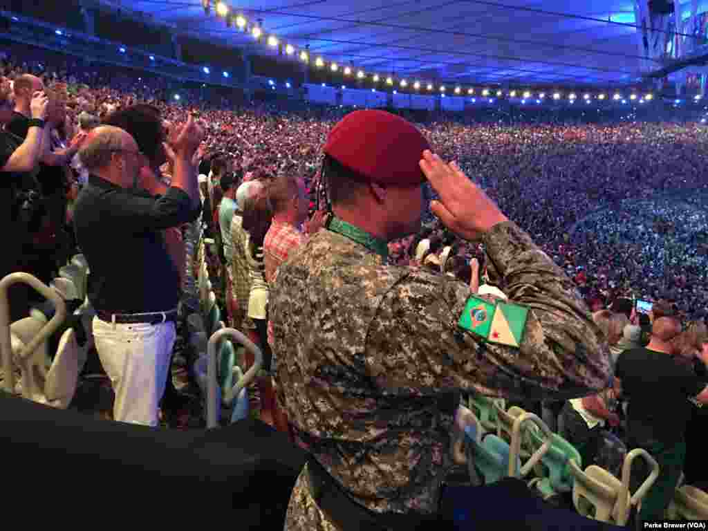 A military policeman salutes during the playing of Brazil’s national anthem at beginning of the Rio Olympics' opening ceremonies in Maracana Stadium, Rio de Janeiro, Brazil, Aug. 5, 2016.