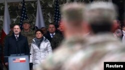 Polish Defense Minister Antoni Macierewicz (L) and Prime Minister Beata Szydlo attend an official welcoming ceremony for U.S. troops deployed to Poland as part of NATO build-up in Eastern Europe, in Zagan, Poland, Jan. 14, 2017.