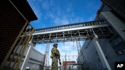 FILE - A Russian serviceman guards an area of the Zaporizhzhia Nuclear Power Station in territory under Russian military control, southeastern Ukraine, May 1, 2022. This pjoto
photo was taken during a trip organized by the Russian Ministry of Defense.