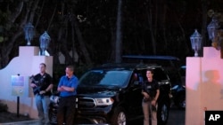 Armed Secret Service agents stand outside an entrance to former President Donald Trump's Mar-a-Lago estate, Aug. 8, 2022, in Palm Beach, Florida. 