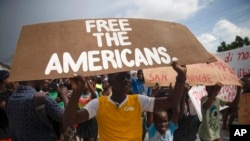 People protest for the release of kidnapped missionaries near the Ohio-based Christian Aid Ministries headquarters in Titanyen, north of Port-au-Prince, Haiti, Oct. 19, 2021.