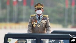 FILE - Senior Gen. Min Aung Hlaing, head of the military council, inspects officers during a parade to commemorate Myanmar's 77th Armed Forces Day in Naypyitaw, Myanmar, Sunday, March 27, 2022.