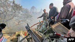 Rescuers gather at the site of a plane crash in Pokhara, Nepal, on Jan. 15, 2023. 