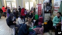 Poland Russia Ukraine War,Ukrainian refugees gather at a railway station in Przemysl, southeastern Poland, on Wednesday, March 23, 2022. Poland has received more than 2 million Ukrainian refugees since the Feb. 24 invasion. (AP Photo/Sergei Grits)