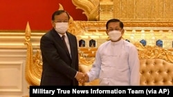 Myanmar State Administration Council Chairman Senior General Min Aung Hlaing, right, shakes hands with Cambodian Foreign Minister Prak Sokhonn during a meeting in Naypyitaw, Myanmar, March 21, 2022. 