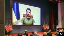 Members of Congress give Ukraine President Volodymyr Zelensky a standing ovation before he speaks in a virtual address to Congress in the U.S. Capitol Visitors Center Congressional Auditorium in Washington, on Wednesday, March 16, 2022.