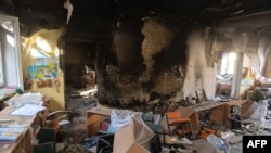 A classroom is littered with debris at a school hit by a Russian air bomb in Kharkiv, Ukraine, March 23, 2022.