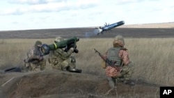 FILE - In this image taken from footage provided by the Ukrainian Defense Ministry Press Service, a Ukrainian soldiers use a launcher with US Javelin missiles during military exercises in Donetsk region, Ukraine, Wednesday, Jan. 12, 2022. 