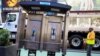 A worker removes the last public payphone near Times Square in New York City, May 23, 2022. 