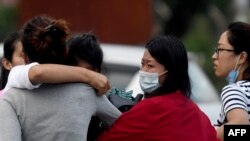 Family members of passengers on board a Twin Otter aircraft operated by Tara Air weep outside the airport in Pokhara, Nepal, May 29, 2022, after the plane with 22 people on board went missing.