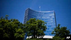 FILE - The UN flag wave on top of an UN building in Geneva, June 14, 2021. A veteran Russian diplomat to the U.N. Office at Geneva handed in his resignation before sending a scathing letter to foreign colleagues inveighing against Russia's invasion of Ukr