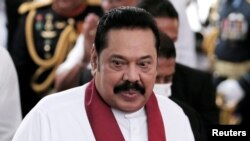 FILE - FILE PHOTO: Sri Lanka's Prime Minister Mahinda Rajapaksa reacts during his swearing in ceremony as the new Prime Minister, at Kelaniya Buddhist temple in Colombo, Sri Lanka, Aug. 9, 2020. 