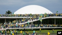 Supporters of Brazil's former President Jair Bolsonaro storm the the National Congress building in Brasilia, Brazil, Jan. 8, 2023.