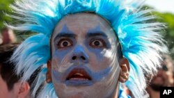 An Argentina soccer fan watches the team lose to Saudi Arabia at a World Cup Group C soccer match, played on a large screen in the Palermo neighborhood of Buenos, Aires, Argentina, Nov. 22, 2022.