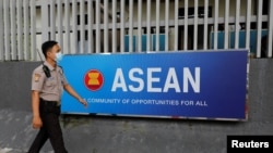 FILE - A security officer walks past the Association of Southeast Asian Nations (ASEAN) sign as he guards outside its secretariat building in Jakarta, Indonesia, Oct. 27, 2022. 