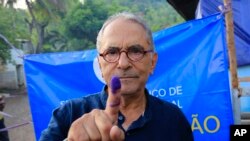 FILE - East Timorese presidential candidate who is also former President Jose Ramos-Horta shows his inked finger after casting his ballot at a polling station during the election in Dili, East Timor on March 19, 2022. (AP Photo/Lorenio Do Rosario Pereira,