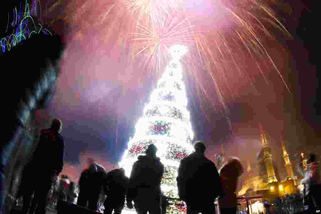 Fireworks explode over Martyrs Square during New Year's celebrations in downtown Beirut, Lebanon, Jan. 1, 2019.