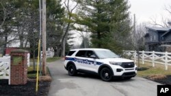 Police secure the entrance to the neighborhood of former Vice President Mike Pence's Indiana home, Friday, Feb. 10, 2023 in Carmel, Ind.