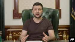 In this image from video provided by the Ukrainian Presidential Press Office, Ukrainian President Volodymyr Zelenskyy speaks from Kyiv, Ukraine, early Sunday, March 20, 2022. (Ukrainian Presidential Press Office via AP)