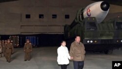 This photo provided on Nov. 19, 2022, by the North Korean government shows North Korean leader Kim Jong Un and his daughter inspecting a missile at Pyongyang International Airport in Pyongyang, North Korea, Nov. 18, 2022. 