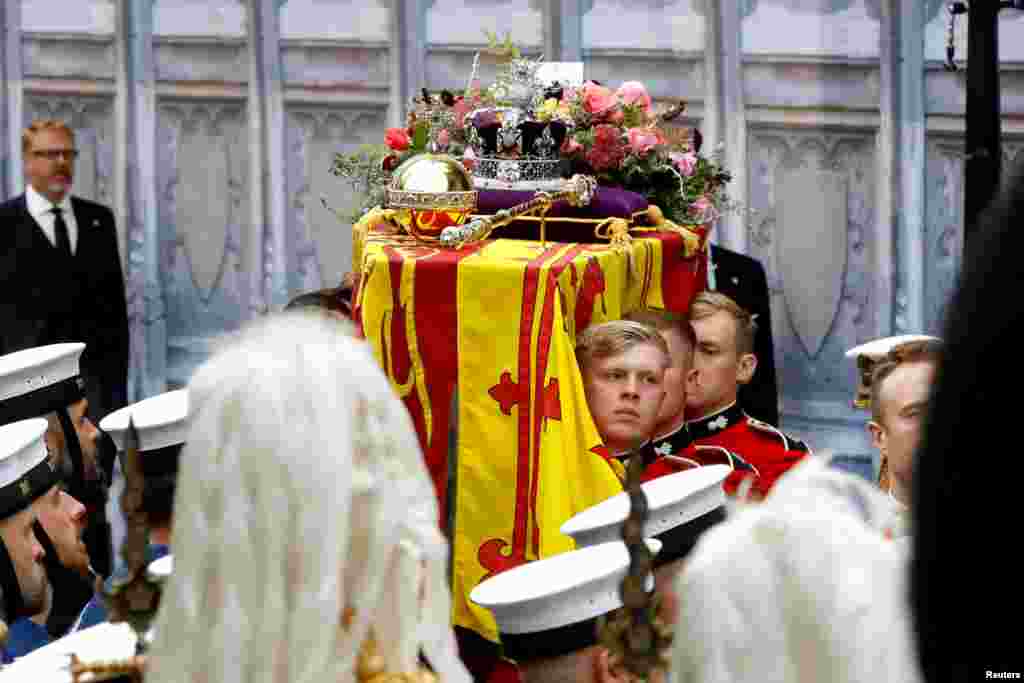 The coffin of Queen Elizabeth II with the Imperial State Crown resting on top i proceeds towards Westminster Abbey, Sept. 19, 2022 in London. 