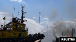 Firefighters work at a site of a Russian missile strike in a sea port of Odesa, as Russia's attack on Ukraine continues, Ukraine, July 23, 2022.