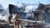 Firefighters work in a residential area damaged by a Russian missile strike in the settlement of Zatoka, Odesa region, Ukraine July 26, 2022, in this photo provided by the State Emergency Service of Ukraine.