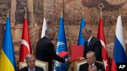 Turkish President Recep Tayyip Erdogan, right, and U.N. Secretary General Antonio Guterres lead a signing ceremony at Dolmabahce Palace in Istanbul, Turkey, Friday, July 22, 2022.