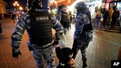 Riot police detain a demonstrator during a protest against mobilization in Moscow, Russia, Sept. 21, 2022.