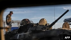 A Ukrainian fighter stands on the top of a tank in Kharkiv, Sept. 9, 2022, amid the Russian invasion of Ukraine.