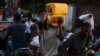 A man carries containers used for oil and gasoline during fuel shortages in Port-au-Prince, Haiti October 30, 2021. Picture taken on October 30, 2021. 