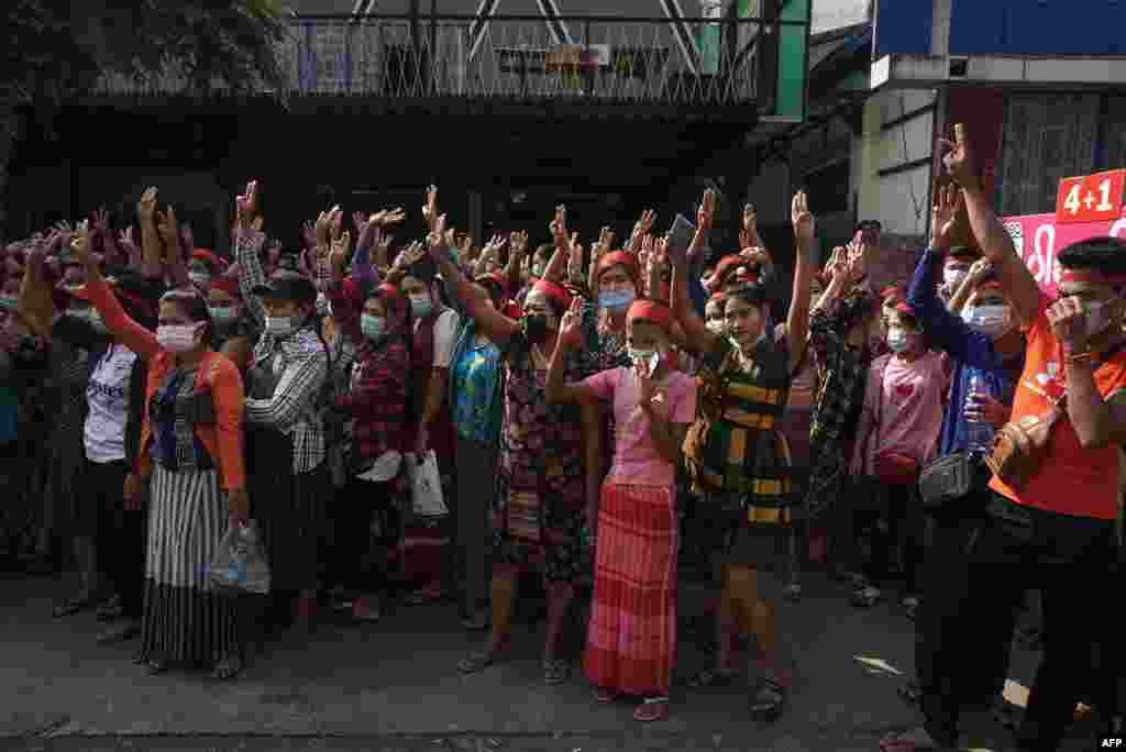 Protesters hold up the three finger salute during a demonstration against the military coup in Yangon on February 6, 2021. (Photo by STR / AFP)