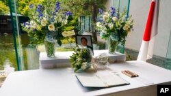 A condolence book open to the page President Joe Biden signed for former Japanese Prime Minister Shinzo Abe, who was assassinated Friday, rests on a table at the Japanese ambassador's residence in Washington, July 8, 2022.