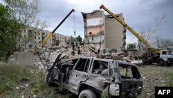 Rescuers clear the scene after a building was partialy destroyed as a result of Russian missile hit on a four-storey residential building in Chasiv Yar, Bakhmut District, eastern Ukraine, on July 10, 2022.