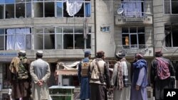 Taliban fighters gather at the site of an explosion in front of a Sikh temple in Kabul, Afghanistan (AP Photo/Ebrahim Noroozi)