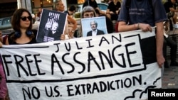 Supporters hold a banner during a protest against the extradition of WikiLeaks' founder Julian Assange from Britain to the U.S., in Athens, Greece, June 20, 2022. 