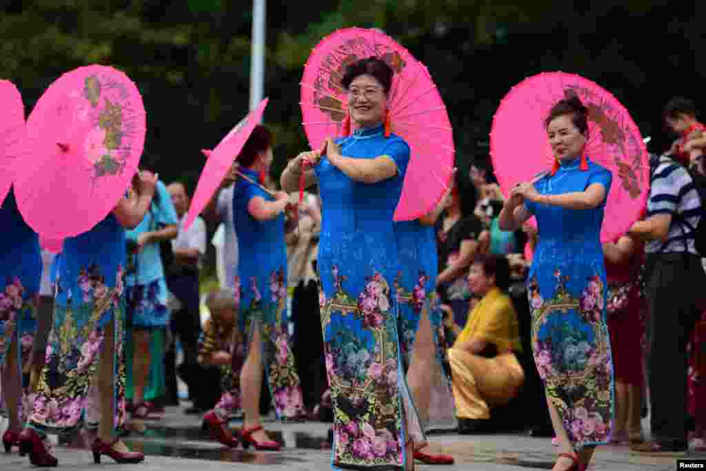 Women in cheongsams take part in a Cheongsam Show ahead of International Women's Day in Qionghai, Hainan province, China March 7, 2018. 