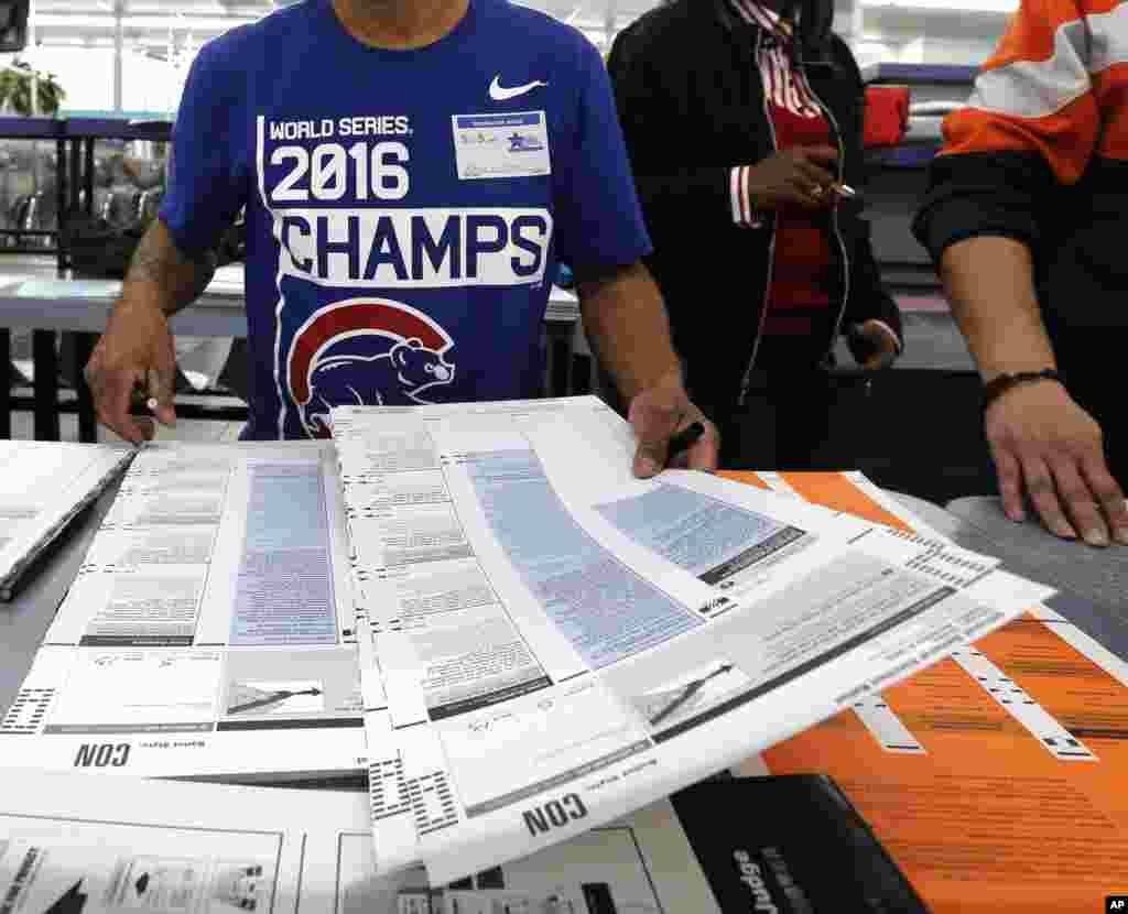 Antonio Martinez, a polling volunteer, prepares ballots at the Su Nueva Lavenderia on Nov. 8, 2016, in Chicago.