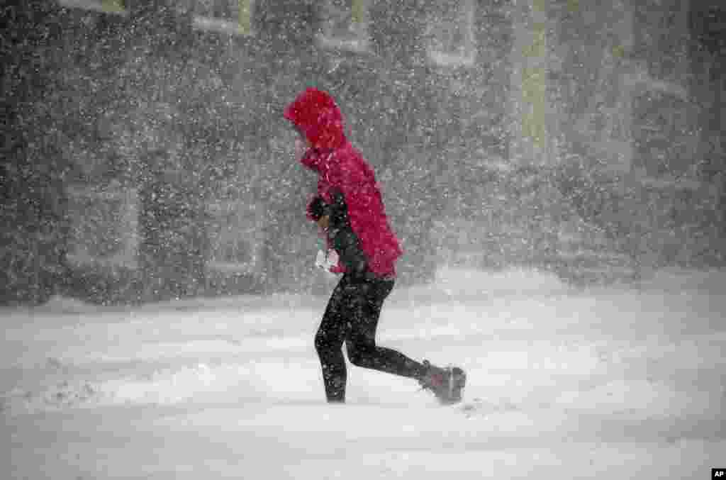 A pedestrian crosses the street in downtown Boston, Jan. 4, 2018.