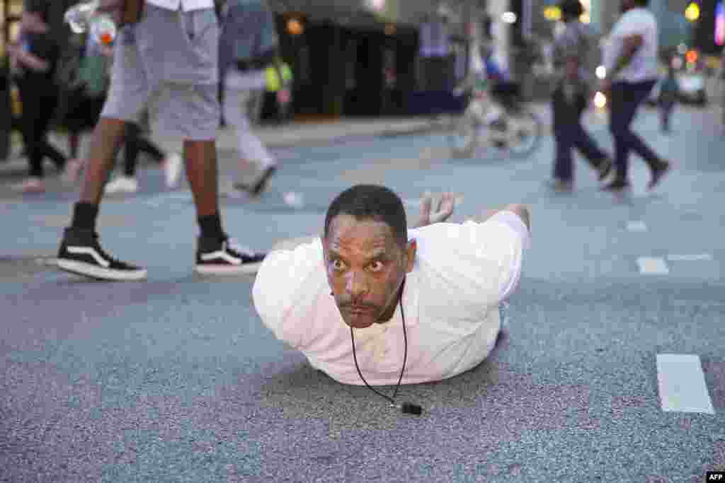 A man lays on the ground after yelling "Don't shoot me" at police during a rally in Dallas, Texas, on Thursday, July 7, 2016 to protest the deaths of Alton Sterling and Philando Castile.