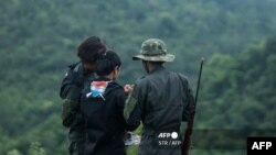 This photo taken on July 5, 2021 shows members of the Karenni People Defense Force (KPDF) during military training at their camp near Demoso in Kayah state. - In their camp hidden in the forested hills of Kayah state near the Thai border, Myanmar anti-junta volunteers practice f