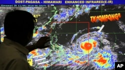 Forecaster Meno Mendoza shows the path of Super Typhoon Mangkhut, locally named "Typhoon Ompong," as it approaches the Philippines at the Philippine Atmospheric, Geophysical and Astronomical Services Administration in Manila, Sept. 12, 2018.